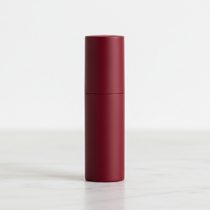 Cylindrical matte lipstick in Burgundy Red on marble surface