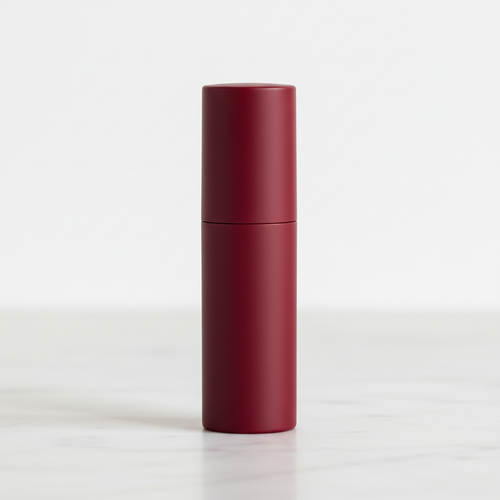 Cylindrical matte lipstick in Burgundy Red on marble surface